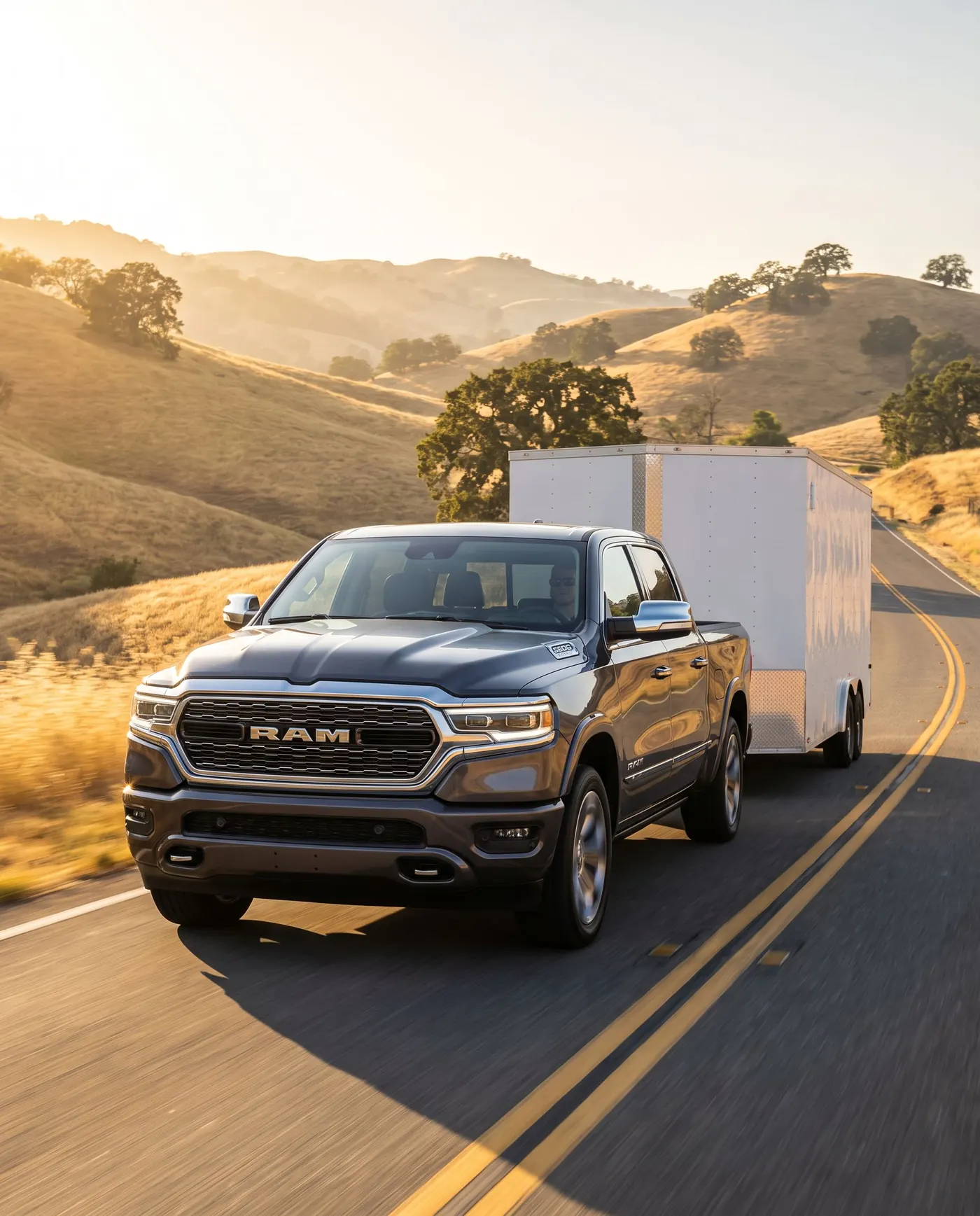 Ram 1500 towing an enclosed trailer up a highway grade