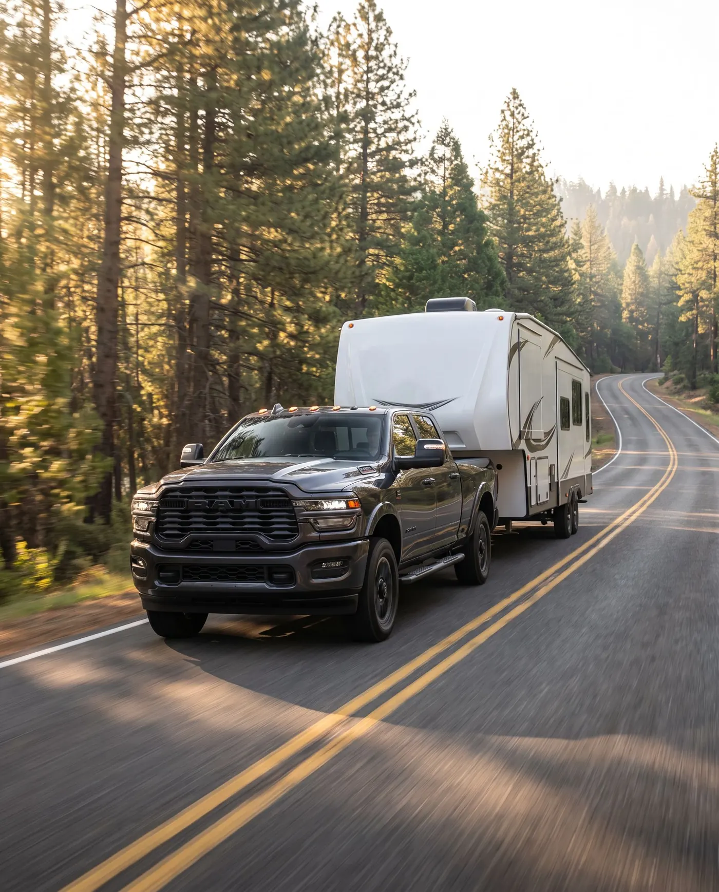 Ram 2500 towing a fifth-wheel camper up a mountain highway